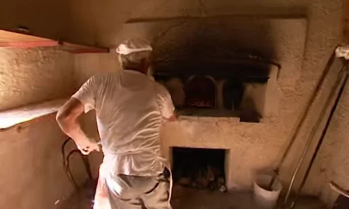 Place the pizza in a preheated pizza oven at a very high temperature (300-350°C).