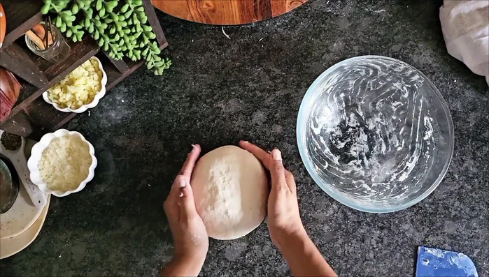 Grease a bowl with oil, place the dough inside, cover, and let it rise for about an hour, or until doubled in size.