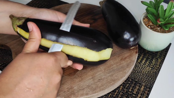 Prepare the eggplant: Wash, peel, and cube the eggplant. (This step is assumed based on common eggplant preparation, as the transcript lacks specific instructions.)
