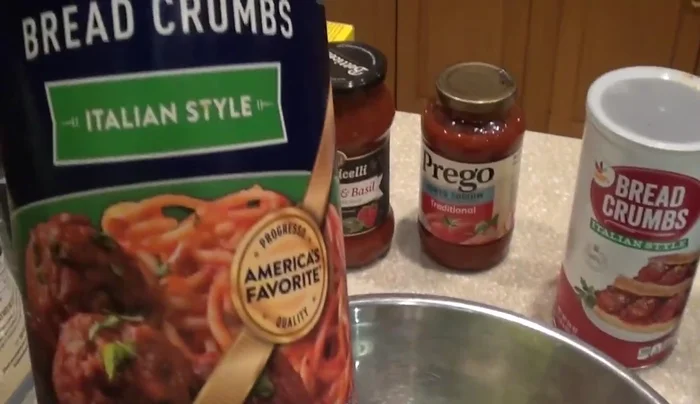 Add Italian breadcrumbs, tomato sauce, and water to the meat mixture. Adjust the amount of water to achieve a paste-like consistency (151.44).