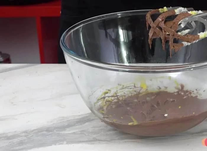 Combine the creamed butter and sugar mixture with the egg yolk and chocolate mixture.