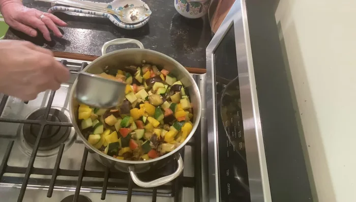 Add vegetable stock and tomato paste. Stir in.