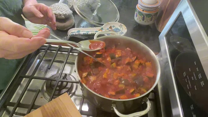 Add chili pepper flakes (or oregano/basil), remaining salt, and fresh black pepper. Stir.