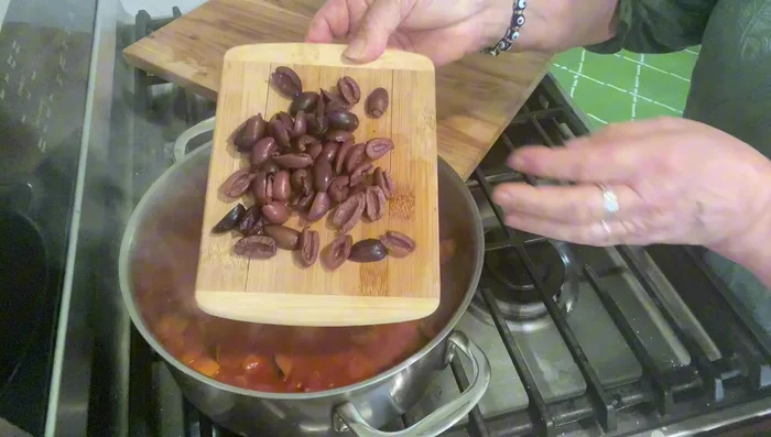 Add pitted olives and stir.
