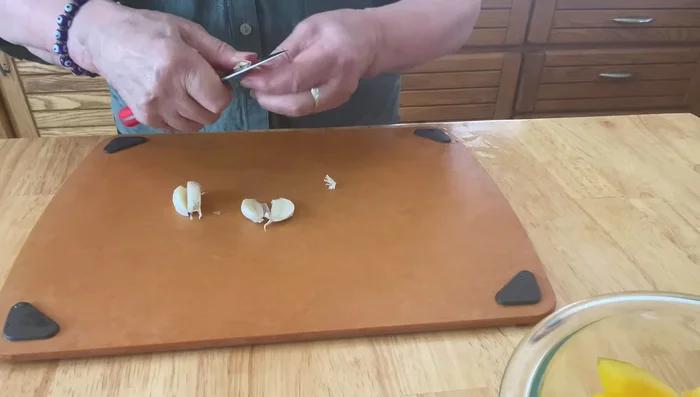Split garlic cloves down the center, peel, and mince finely.