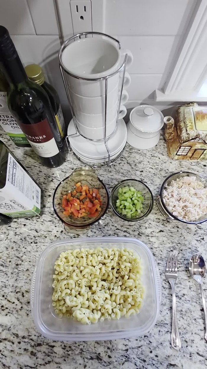 Combine the cooked noodles, tuna, diced celery, and diced red bell pepper in a bowl.