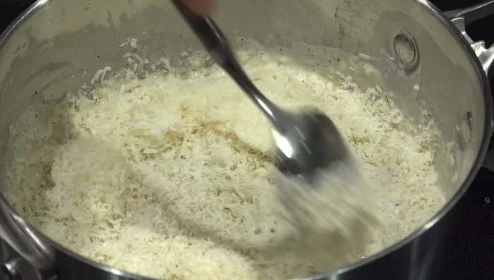 Stir in the grated parmesan cheese. Remove from heat and let cool slightly. (140)