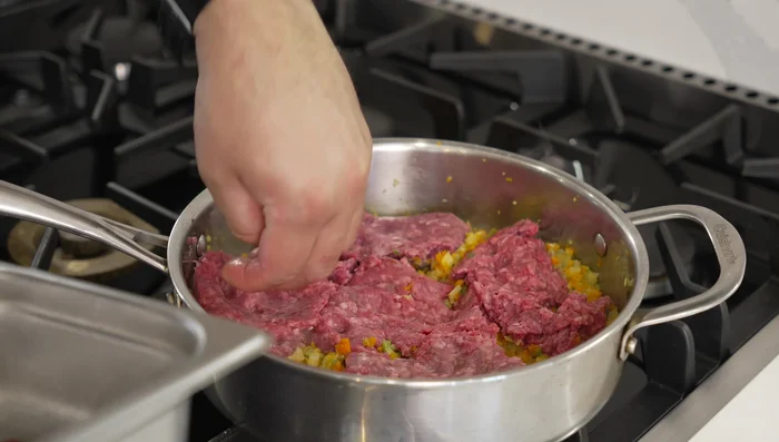 Add the minced beef, season with salt and pepper, and cook for 5 minutes, breaking up any large clumps.