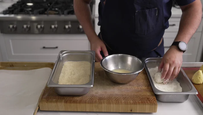 Bread the Arancini: Coat each arancini in flour, then egg, then panko breadcrumbs.