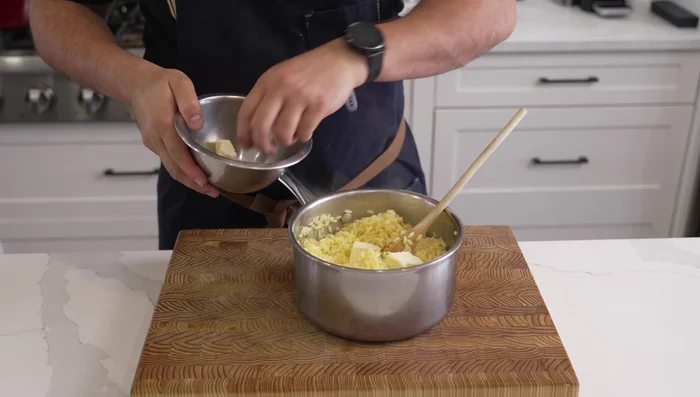 Stir in 4-5 tablespoons of butter and spread the rice thinly on a sheet pan to cool quickly in the fridge.