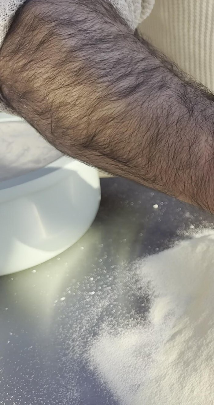 Add pizza sauce, mozzarella, and parmesan cheese to the pizza crust, leaving a small border.