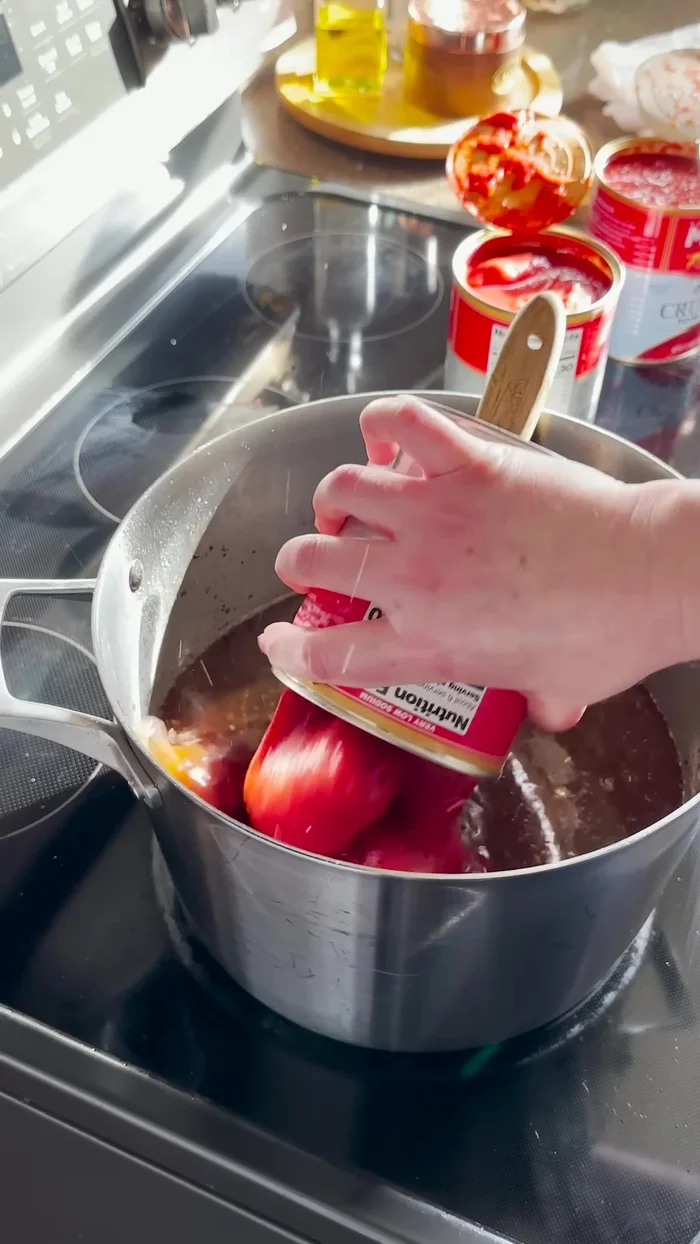 Add dry red wine and scrape the bottom of the pan.