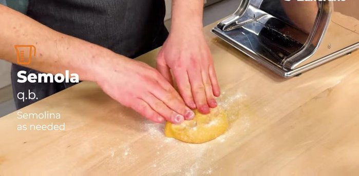 Take a portion of the dough and work it with a pinch of semolina to prevent sticking. Roll it out using a rolling pin or pasta machine, passing it through multiple times from widest to narrowest thickness.