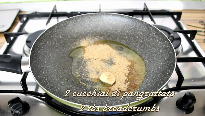 Prepare the dressing: Heat olive oil in a pan. Add minced garlic and breadcrumbs, and toast until golden brown (about 2-3 minutes). Add lemon zest.