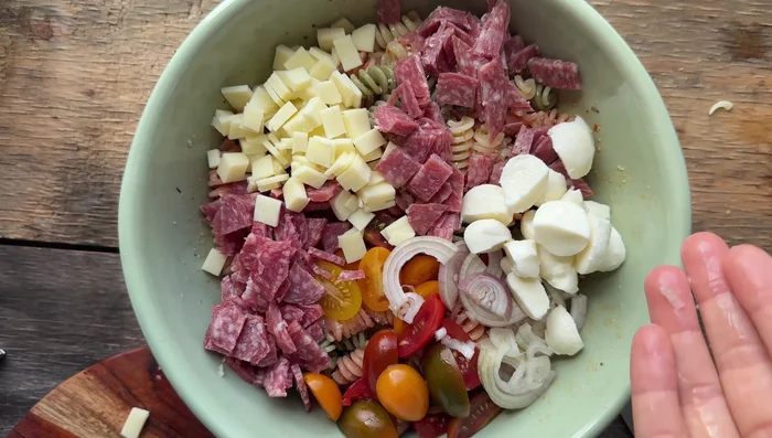 Add the chopped meats, shallot, tomatoes, and mozzarella to the pasta mixture. Gently toss to combine.