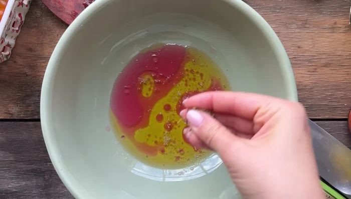 In a bowl, whisk together the dressing: 1/4 cup red wine vinegar, 1/2 cup olive oil, 1 grated clove of garlic, parmesan cheese, salt, pepper, Italian seasoning, and optional Calabrian chili paste or hot pepper flakes.