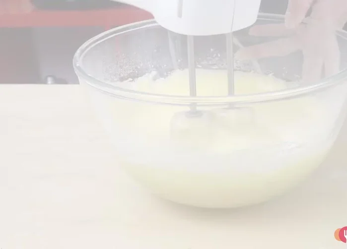 Transfer the mixture into a buttered and floured cake tin.