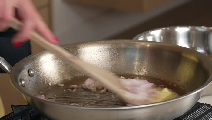 In the same pan, build the sauce: Sauté shallot and garlic. Add mushrooms and cook until softened. Stir in flour, then gradually whisk in Marsala wine and chicken stock. Add Dijon mustard, rosemary, and thyme. Simmer until the sauce has reduced and thickened.