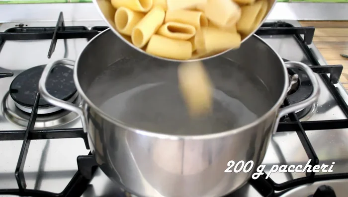 Cook paccheri pasta al dente. Reserve some pasta water before draining.