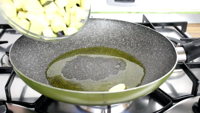 Sauté the eggplant in olive oil with ½ clove of garlic, salt, and 2 basil leaves over high heat until golden brown (no need to add water).