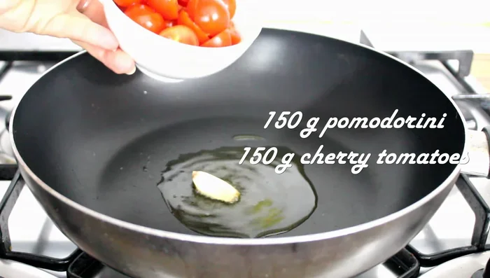 In a separate pan, sauté cherry tomatoes with 1 clove of garlic, salt, and oregano for 5-8 minutes until they release their sauce.