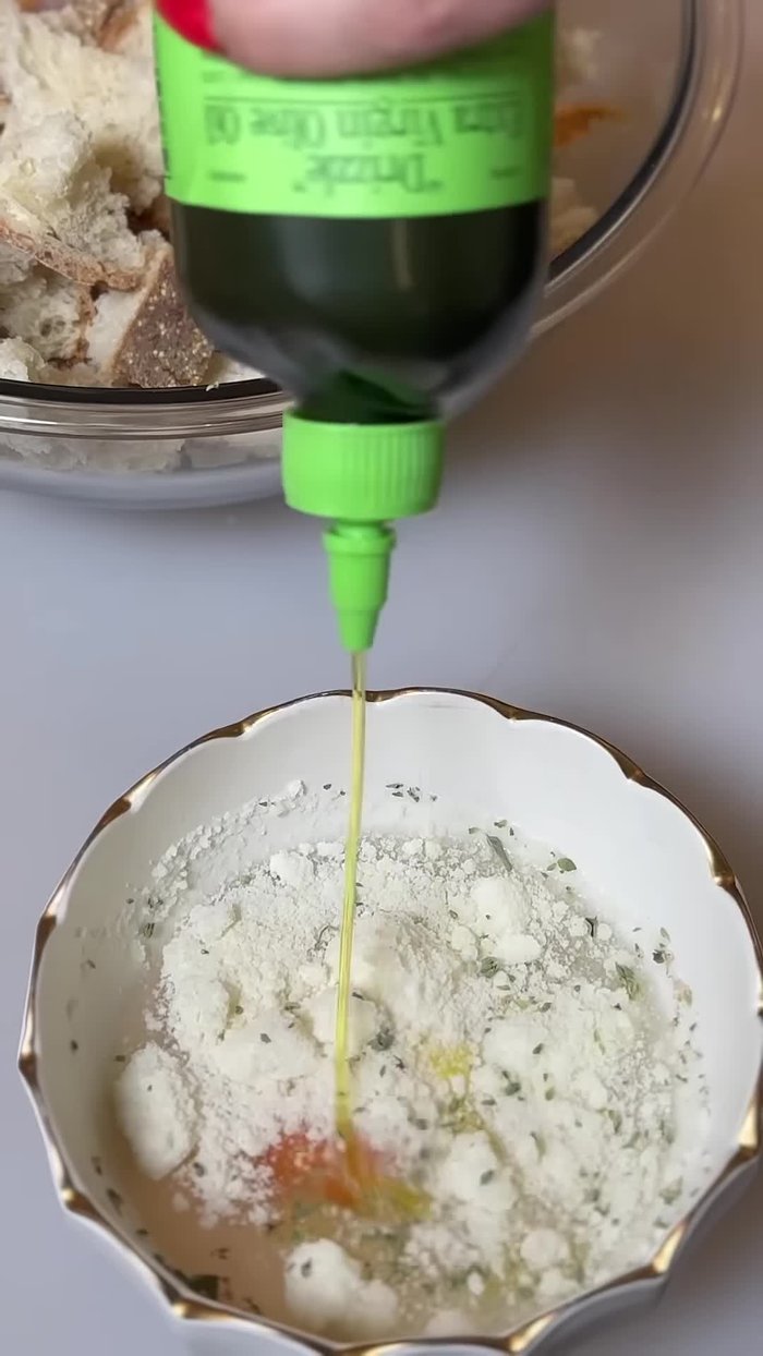 In a bowl, combine the bread pieces, one egg, 1/3 cup of water, Pecorino Romano cheese, salt, pepper, a little sprinkle of cheese, and oregano. Mix well to combine. This mixture will act as the binder for your crust.