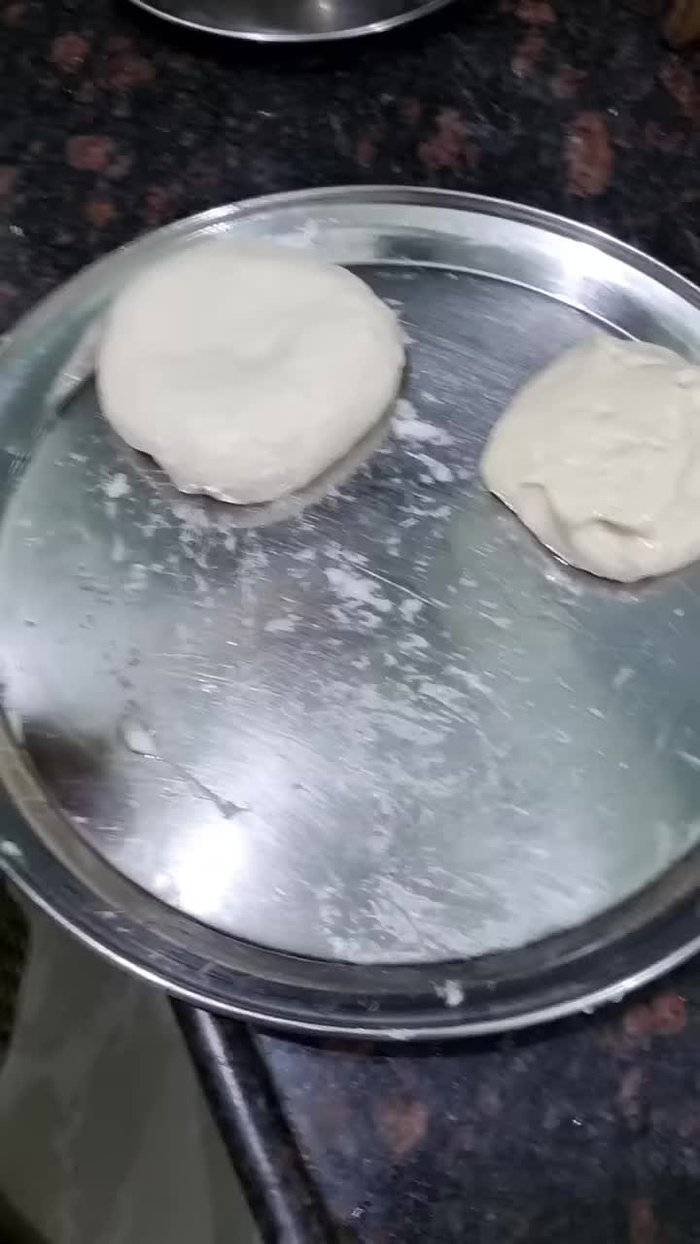 Gently flatten each dough piece using a little oil and flour to prevent sticking.