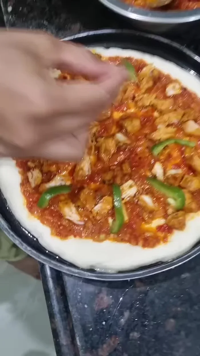 Add your desired toppings (example: chicken, capsicum, onion).