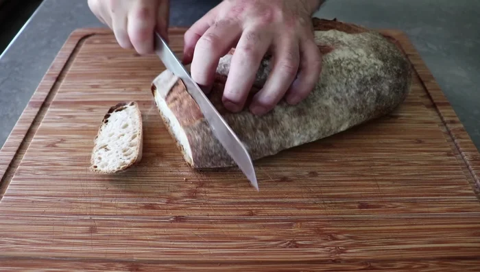 Cut the bread into 1-inch cubes. Spread in a single layer and let sit overnight to slightly stale.