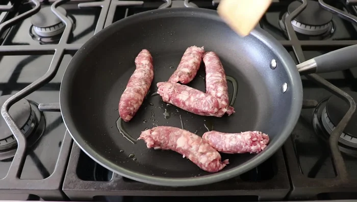 Cook sausage in a pan with olive oil until browned. Crumble as you cook.