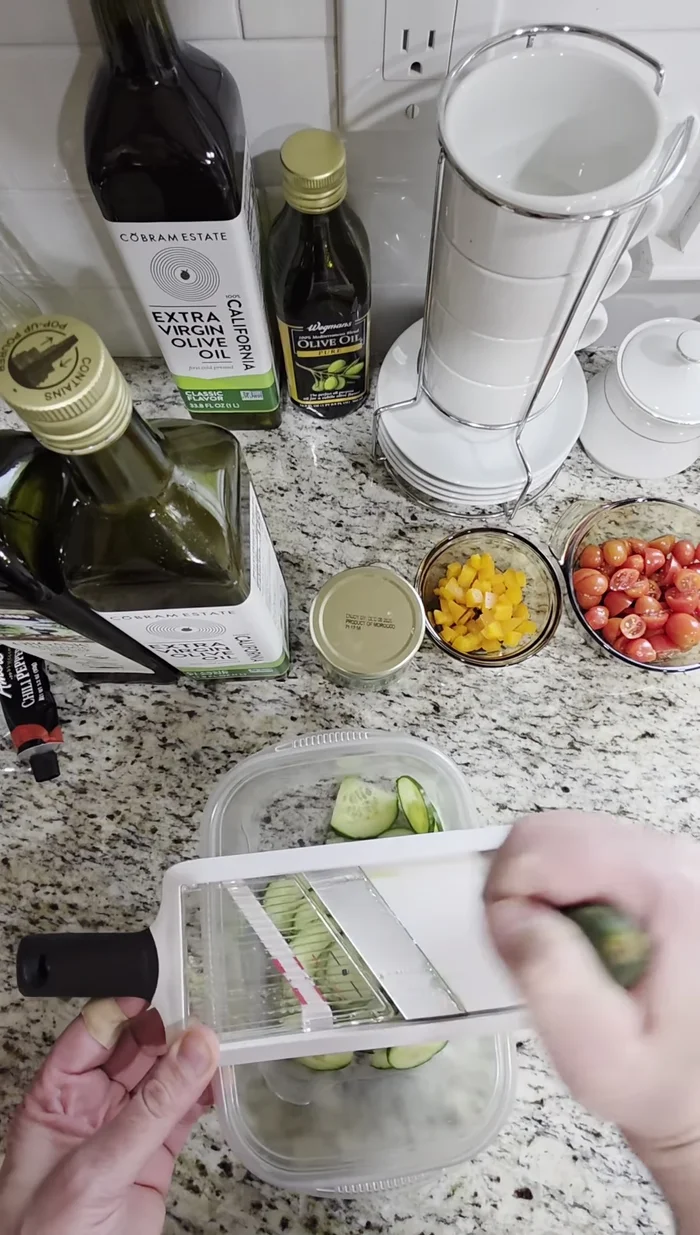 Combine ingredients: Combine the sliced cucumber, shredded chicken, and halved grape tomatoes in a bowl.