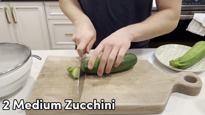 Remove ends from zucchini and grate using large holes of a box grater. Turn on its side halfway through for easier grating.