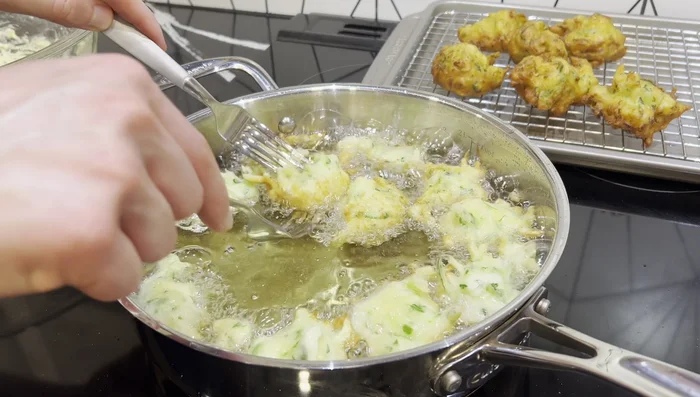 Fry for about 3 minutes per side, or until golden brown, flipping with forks. Maintain oil temperature by adjusting heat as needed.