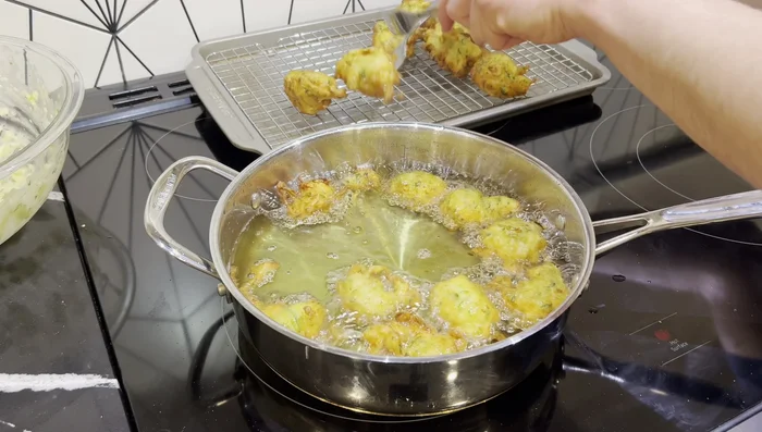 Remove puffs and place on a wired rack over a baking sheet to drain excess oil while remaining crispy. Repeat with remaining batter.