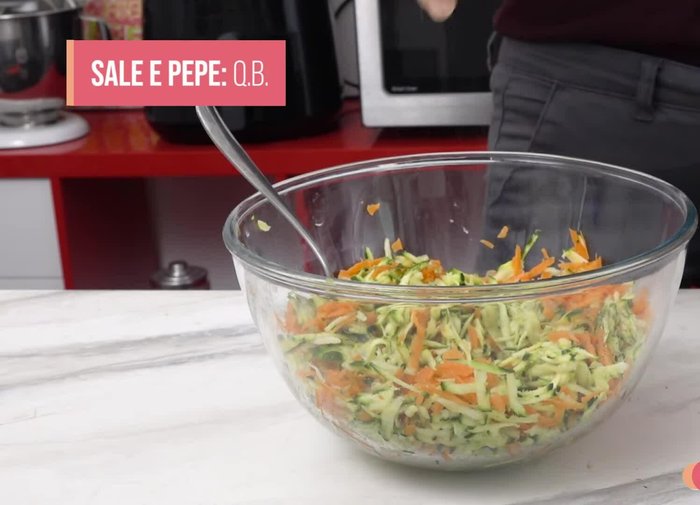 Add salt, pepper, and a drizzle of olive oil to the grated vegetables. Mix well.