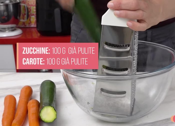 Grate 100g of courgettes and 100g of carrots.