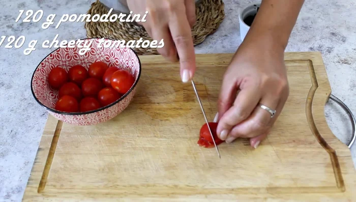 Cut cherry tomatoes into wedges and season with salt and oil.