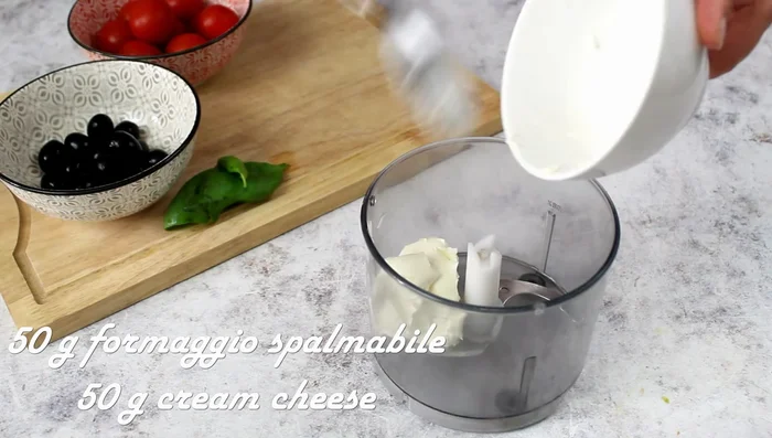 For the olive pasta: Blend spreadable cheese, olives, basil, and water to create olive cream.
