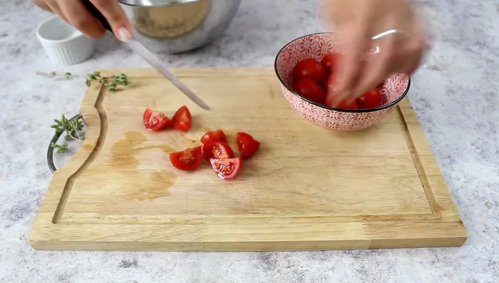 Season cherry tomatoes with salt, oil, and oregano. Combine cold pasta, tomato mixture, and olive cream.