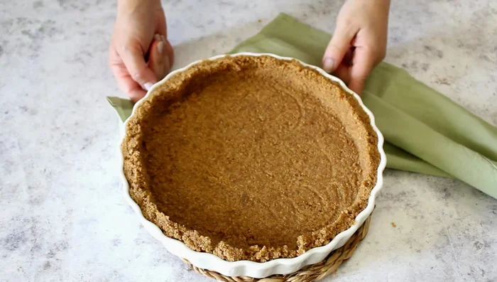 Refrigerate the tart base while preparing the filling.