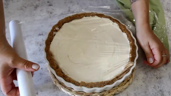 Cover the tart with cling film and refrigerate for at least 6 hours to allow the base to solidify.