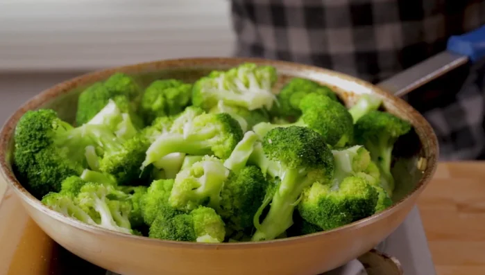 Toss the broccoli in the garlic oil, adding more olive oil if needed. Add a little water to prevent burning.