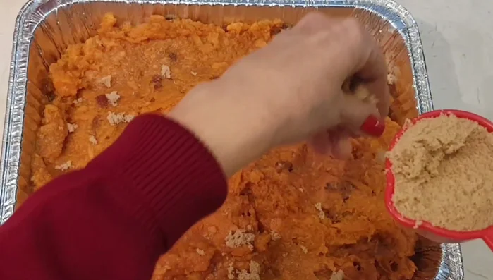 Transfer the mixture to a baking dish. Sprinkle with 1/4 cup (or to taste) of brown sugar and some extra chopped pecans.