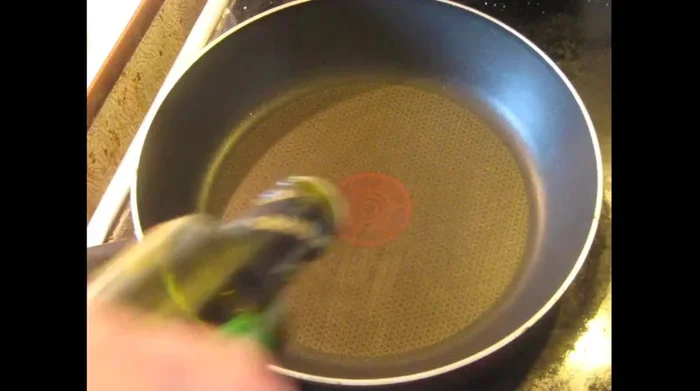 Heat olive oil in a skillet with crushed garlic (for flavoring the oil only; discard garlic later).
