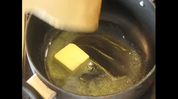 Once the butter foams, add 2 tablespoons of flour and stir.