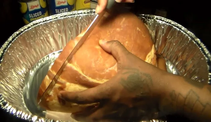 Rinse the thawed ham and cut 1/4 inch deep lines into the ham to allow the juice to penetrate.