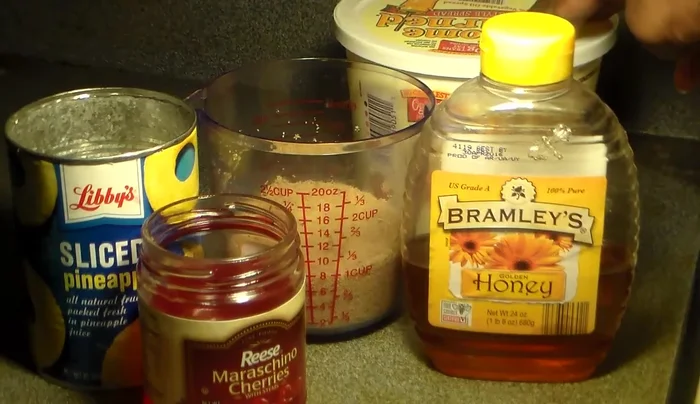 Make the glaze by combining honey, brown sugar, pineapple juice, and cherry juice in a pot over low heat. Stir until combined.