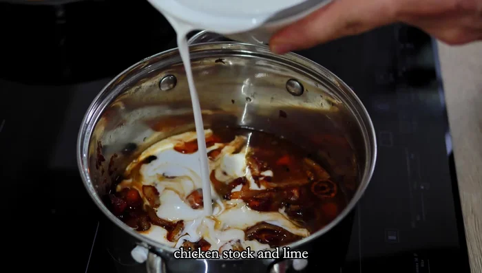 Transfer roasted vegetables to a pot. Add coconut cream, chicken stock, and lime. Cook for a few minutes until smooth.