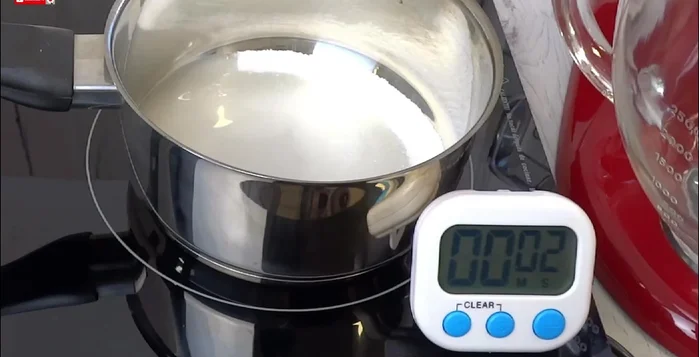 In a saucepan, combine 200g sugar and 70ml water. Boil over medium-high heat until it reaches 118°C (244°F).