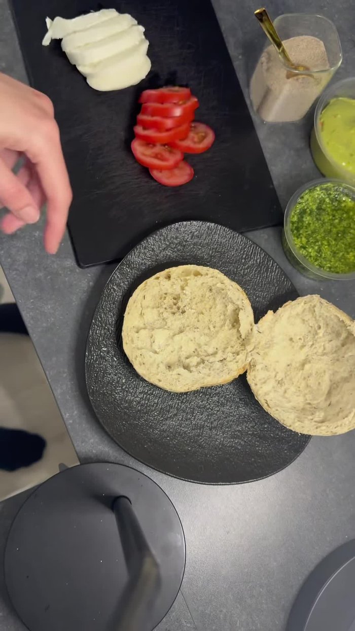 Start with pesto. Spread it generously on one side of the bread.